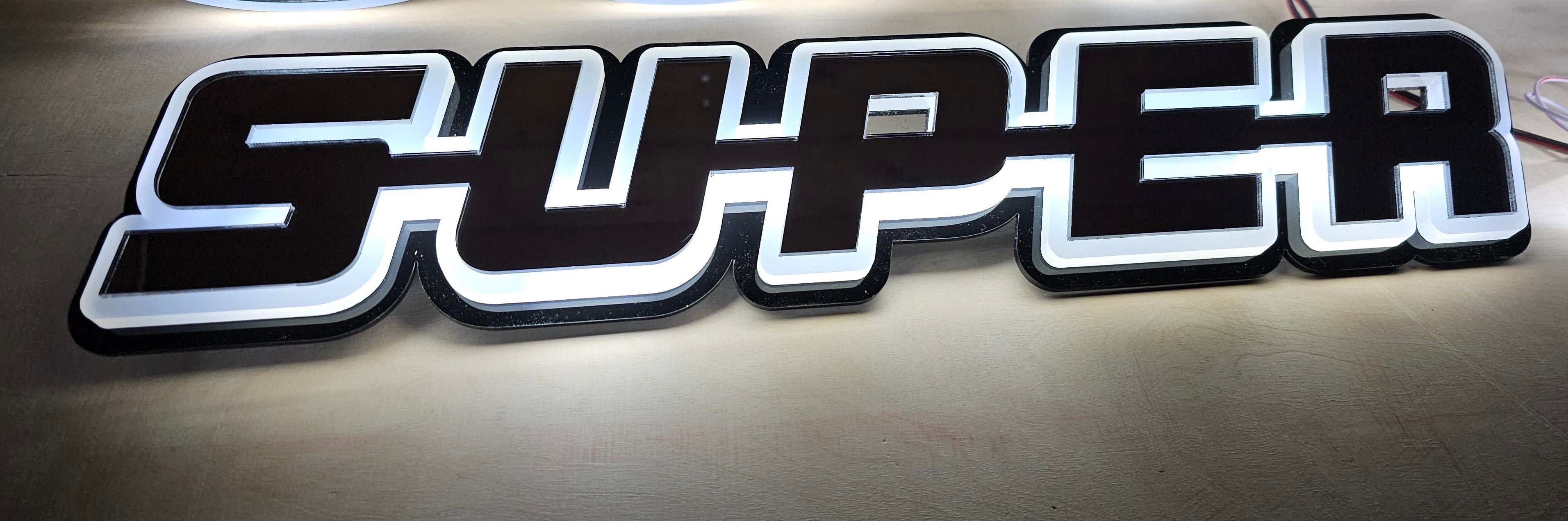 Scania sign "Super" (orange, white, red)